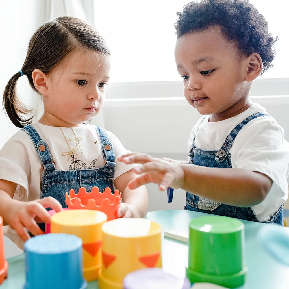 Two toddlers playing with toys