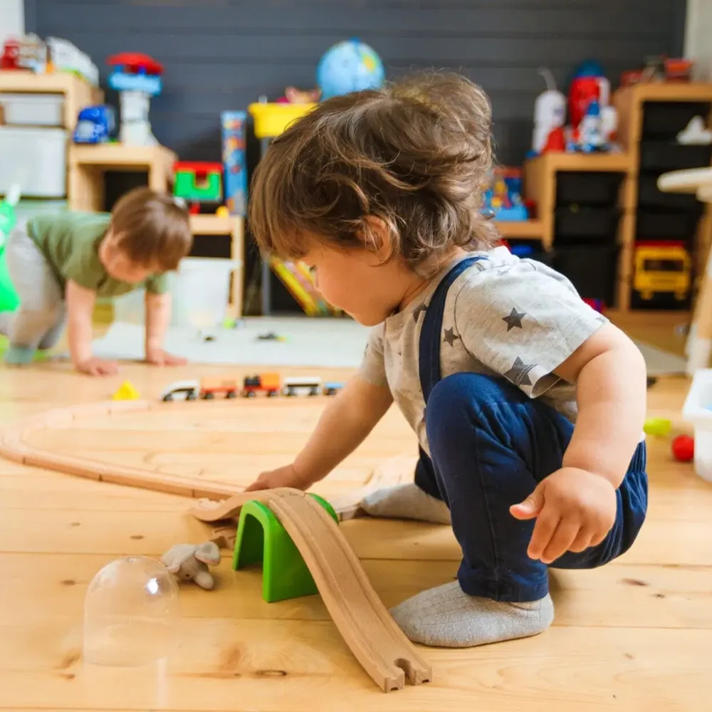 A child playing with a ramp at a Red Balloon Child Care Center daycare
