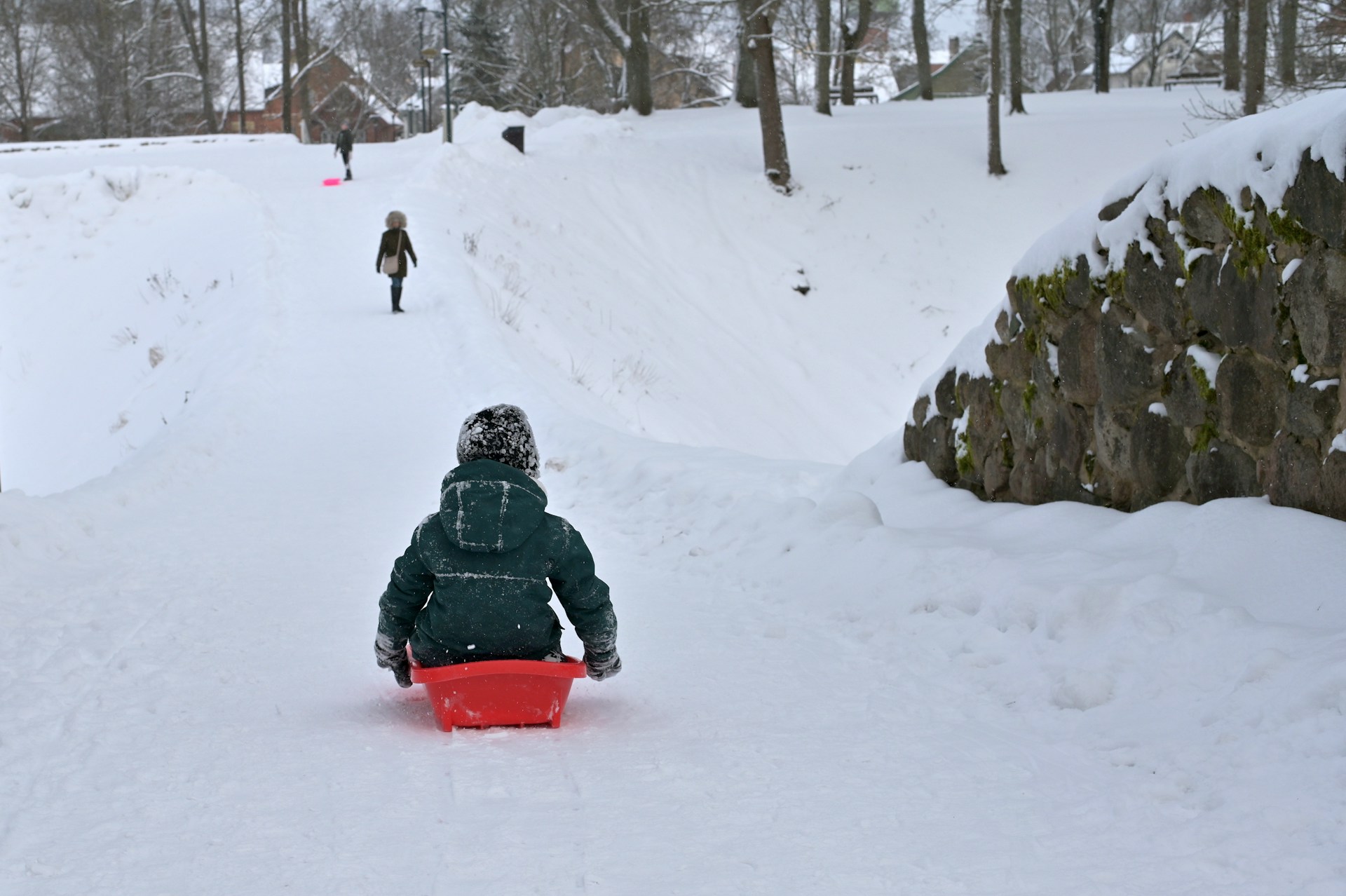 Child sledding down a hill