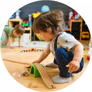 A child using a ramp toy to play at a Red Balloon Child Care Center daycare
